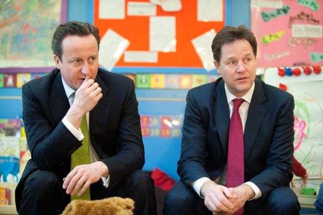 Britain's Prime Minister David Cameron, left, and Deputy Prime Minister Nick Clegg visit the Wandsworth Day Nursery in London, Tuesday March 19, 2013. Britain's government is expected to create a better childcare system for parents. (AP Photo/Jeremy Selwyn, Pool)