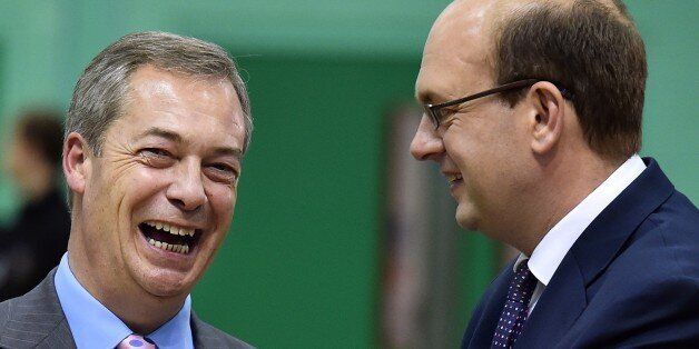 UK Independence Party (UKIP) party leader Nigel Farage (L) and UK Independence Party (UKIP) parliamentary candidate Mark Reckless (R) speak before the by-election announcement in Rochester, Kent on November 21, 2014. Britain's anti-European Union UK Independence Party (UKIP) claimed a second seat in parliament in the town of Rochester, foreshadowing a possible political upheaval in next year's general election. AFP PHOTO / BEN STANSALL AFP PHOTO / BEN STANSALL (Photo credit should read BEN STANSALL/AFP/Getty Images)