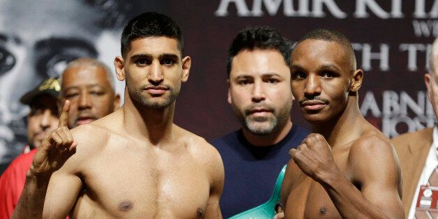 Amir Khan, left, and Devon Alexander pose after a weigh-in Friday, Dec. 12, 2014, in Las Vegas. The two are scheduled to fight in a welterweight bout Saturday in Las Vegas.(AP Photo/John Locher)