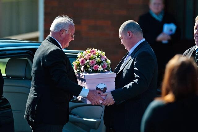 Tuesday 11 March 2014 Pictured: Dad Patrick Mullane (R) helps carry the tiny coffin from the car Re: A funeral is taking place in Pontyberem Catholic Church for six day old Eliza-Mae Mullane who died after an incident at the family home in Carmarthenshire in the morning of 18 February 2014, where police later seized two dogs, an Alaskan Malamute called Nisha and a collie cross that were destroyed following the baby girl's death. Parents Sharon John and Patrick Mullane said previously that they would cherish the short time they had with her.