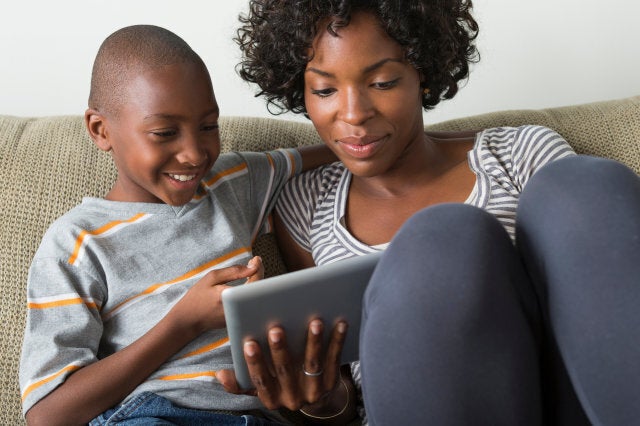 Mother and son using digital tablet