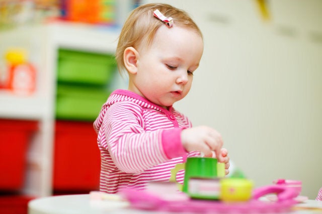 Toddler girl playing with toys