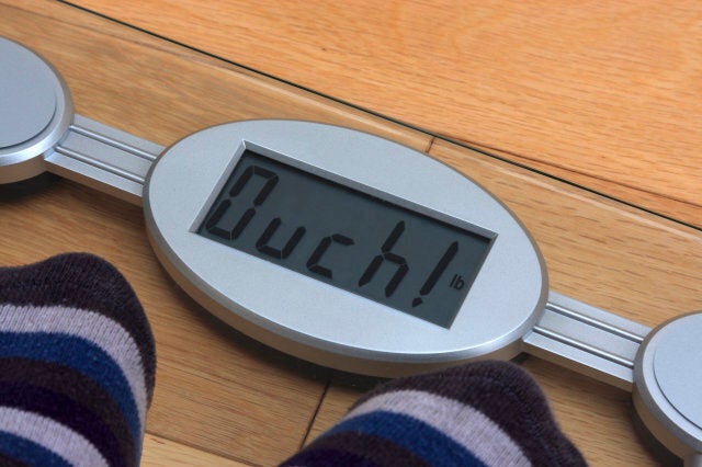 Digital bathroom scales with reading altered to make the word 'ouch!'.