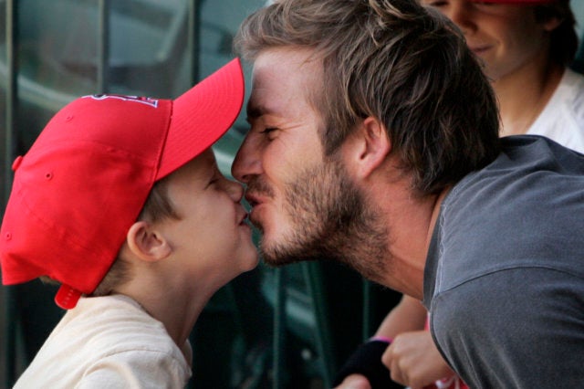 Soccer star David Beckham gets a kiss from son Cruz