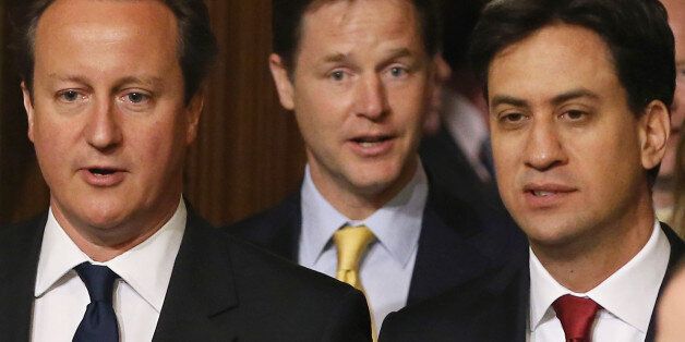 Prime Minister David Cameron (left), Deputy Prime Minister Nick Clegg (centre) and Leader of the Opposition Ed Miliband walk through the Members' Lobby before the Queen's Speech at the State Opening of Parliament in London.