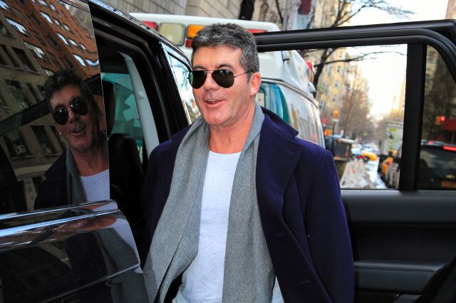 NEW YORK, NY - FEBRUARY 14: A very happy Simon Cowell is seen arriving at Lenox Hill Hospital on February 14, 2014 in New York City. Simon Cowell has arrived in New York to visit his partner Lauren Silverman who has reportedly gone into labour. (Photo by Alessio Botticelli/GC Images)