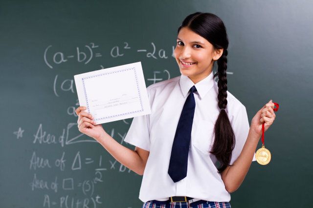 Young Girl showing her awards of excellence.