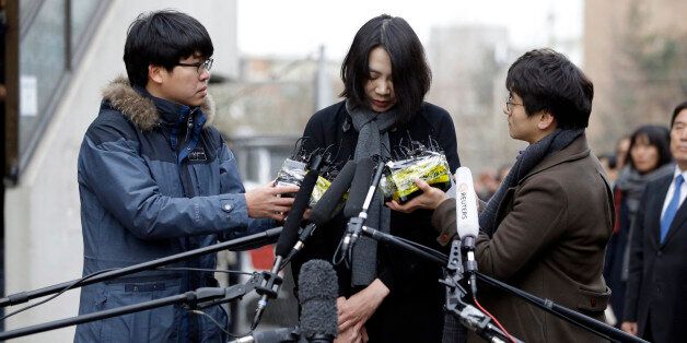 Cho Hyun-ah, who was head of cabin service at Korean Air and the oldest child of Korean Air chairman Cho Yang-ho, speaks to the media upon her arrival for questioning at the Aviation and Railway Accident Investigation Board office of Ministry of Land, Infrastructure and Transport in Seoul, South Korea, Friday, Dec. 12, 2014. The chairman of Korean Air Lines Co. apologized Friday for the behavior of his adult daughter who delayed a flight in an incident now dubbed