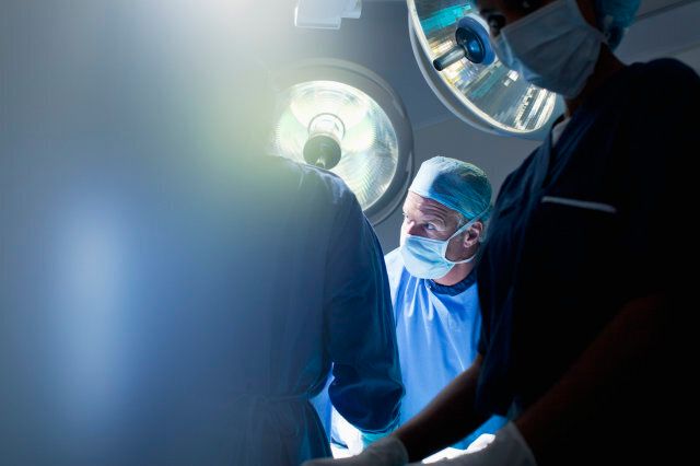 Surgeons working in operating room