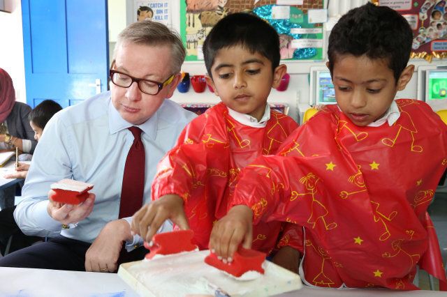 Education Secretary Michael Gove looks confused by a paint sponge