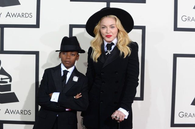 Madonna, right, arrives with her son David Ritchie at the 56th annual GRAMMY Awards at Staples Center on Sunday, Jan. 26, 2014, in Los Angeles. (Photo by Jordan Strauss/Invision/AP)