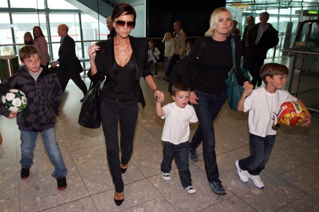 Victoria Beckham arrives from Milan at Terminal 5 at Heathrow Airport, Middlesex, with sons Brooklyn (left), Romeo (right) and Cruz.