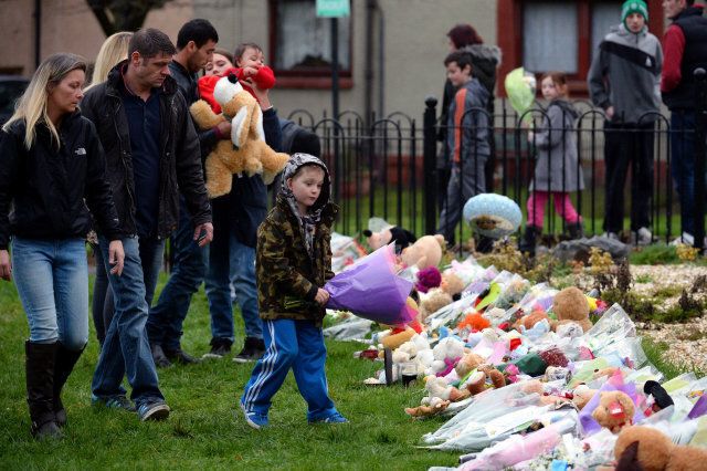 EDINBURGH, SCOTLAND - JANUARY 18: Members of the public lay tributes in Ferry Gate Crescent near the home of three year old Mikaeel Kular on January 18, 2014 in Edinburgh,Scotland. Police have secured a bungalow in Dunvegan Acenue in Kirkcaldy where a young boy's body believed to be Mikaeel Kular, 3, was found last night (Photo by Jeff J Mitchell/Getty Images)