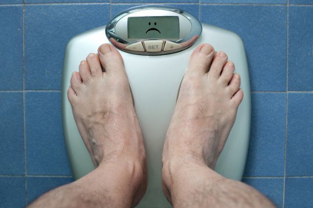 One man weighing himself.