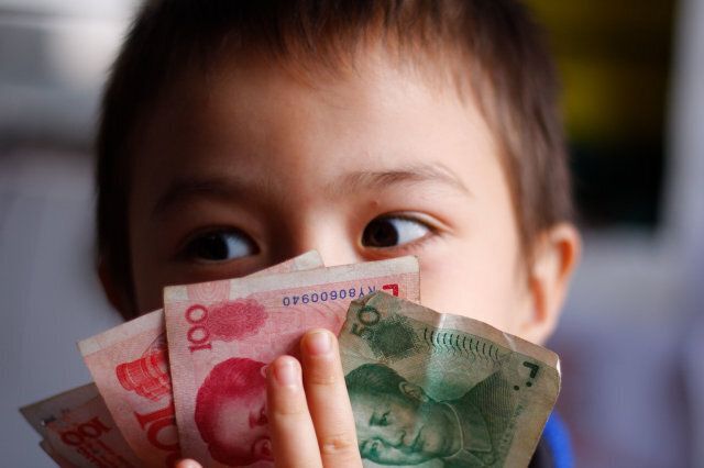 Boy playing with Chinese money