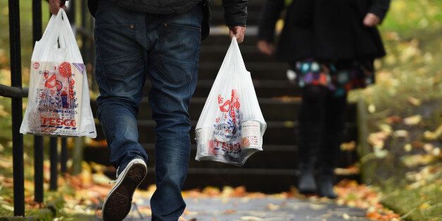 GLASGOW, SCOTLAND - OCTOBER 23: A man walks with Tesco supermarket bags on October 23, 2014 in Glasgow, Scotland.Tesco one of Britains biggest supermarkets has announced a 91.9% plunge in pre-tax profits to Â£112 million for the first half of the year. (Photo by Jeff J Mitchell/Getty Images)