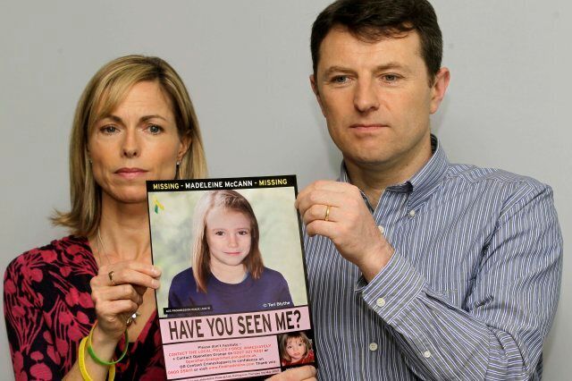 Kate and Gerry McCann pose for the media with a missing poster depicting an age progression computer generated image of their daughter Madeleine