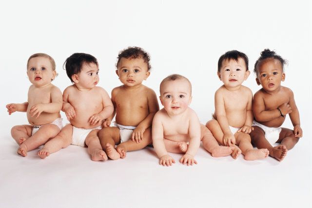 Six babies (18-21 months) sitting on the floor, portrait