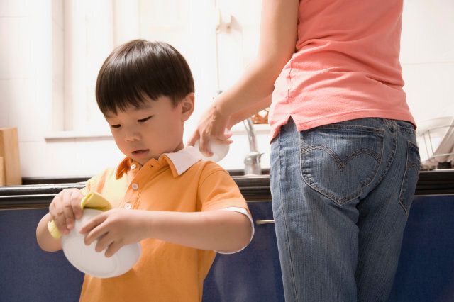 Boy helping his mother in the kitchen
