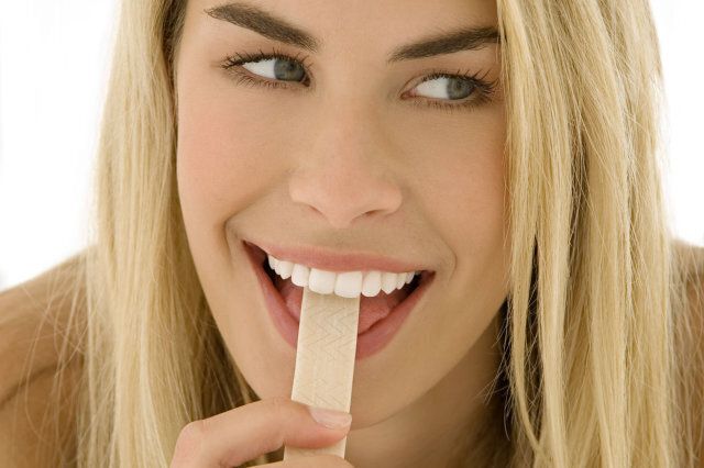 Woman eating stick of chewing gum
