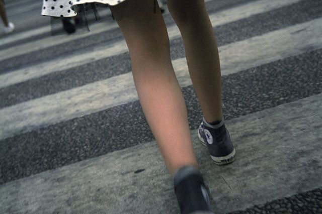 Low section view of a girl crossing the road