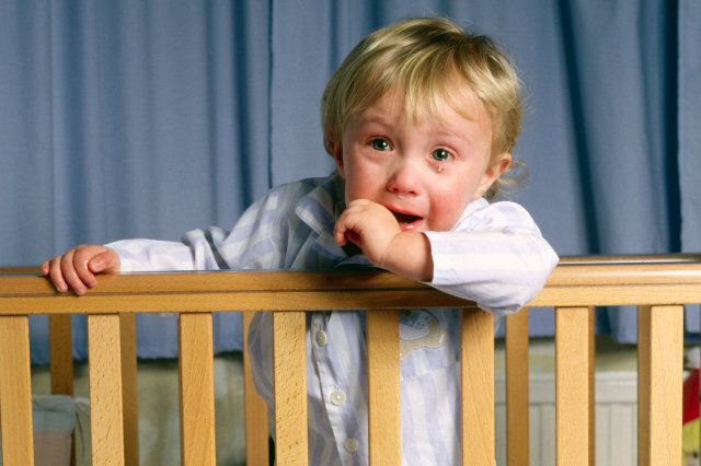 Toddler aged 2 years upset in cot