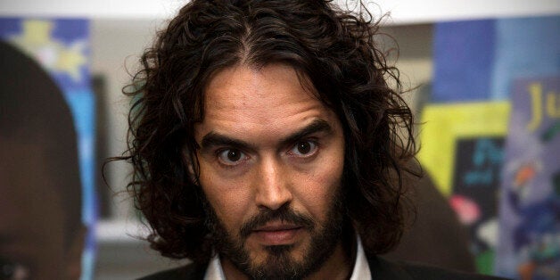 LONDON, ENGLAND - NOVEMBER 25: Russell Brand poses for photographs as he arrives to deliver The Reading Agency Lecture at The Institute of Education on November 25, 2014 in London, England. Russell Brand will deliver 'a manifesto on reading' which will be in part personal, sharing his own experience of books and reading while growing up in the UK. (Photo by Carl Court/Getty Images)