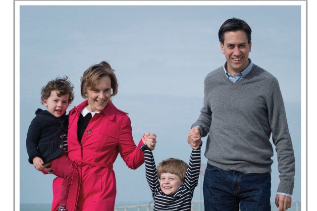 EDITORIAL USE ONLYThe Miliband familyÕs Christmas card for 2013 taken by the Press Association's Chief Political Photographer Stefan Rousseau featuring the Labour Party Leader Ed Miliband and his wife Justine taking their children Daniel (right) and Sam (left) for a walk along Brighton beach.