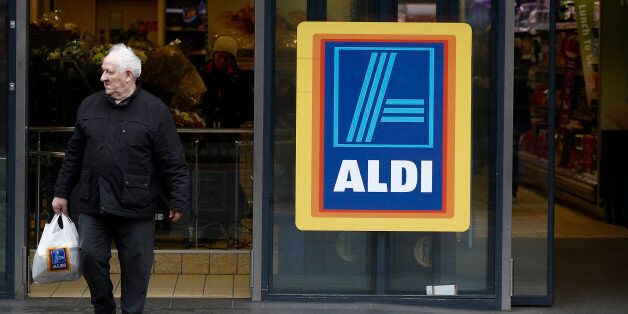 A customer exits an Aldi Stores Ltd. supermarket in the Kilburn district of London, U.K., on Monday, Dec. 22, 2014. German discounters Aldi and Lidl spent twice as much on British advertising as U.K. grocery leader Tesco Plc in the initial buildup to Christmas as they sought to build on market share gains at the seasonal peak. Photographer: Simon Dawson/Bloomberg via Getty Images