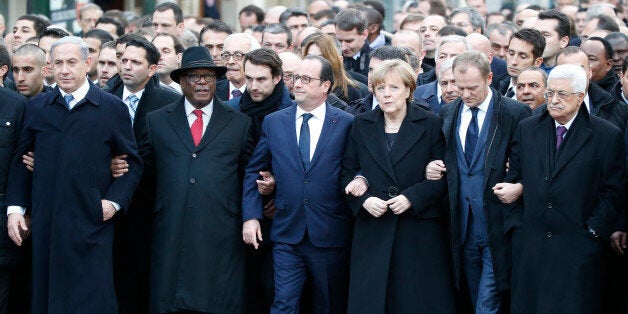 Front from the left, Israeli Prime Minister Benjamin Netanyahu, Malian President Ibrahim Boubacar Keita, French President Francois Hollande, German Chancellor Angela Merkel, EU Council President Donald Tusk and Palestinian Authority President Mahmoud Abbas, process arm-in-arm in Paris, France, Sunday, Jan. 11, 2015. Thousands of people began filling Franceâs iconic Republique plaza, and world leaders converged on Paris in a rally of defiance and sorrow on Sunday to honor the 17 victims of three days of bloodshed that left France on alert for more violence. (AP Photo/Michel Euler)