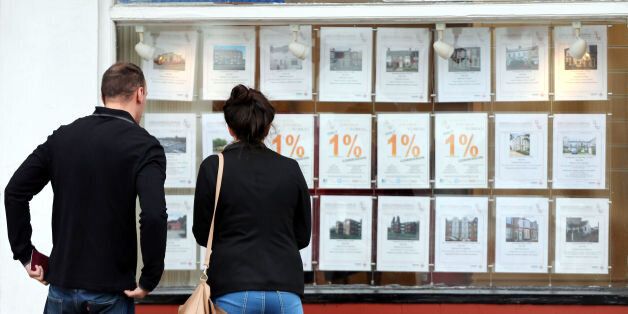 Embargoed to 0001 Tuesday January 6 File photo dated 08/10/13 of a couple looking at houses for sale in a estate agents window. The number of first-time buyers climbing onto the property ladder jumped by more than a fifth last year to stand at a seven-year high, figures today revealed.