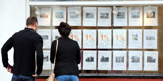 Embargoed to 0001 Tuesday January 6 File photo dated 08/10/13 of a couple looking at houses for sale in a estate agents window. The number of first-time buyers climbing onto the property ladder jumped by more than a fifth last year to stand at a seven-year high, figures today revealed.