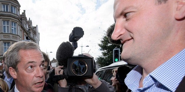 UK Independence Party (UKIP) leader Nigel Farage (C) addesses the media as newly elected UKIP MP Douglas Carswell (R) looks on in Clacton-on-Sea, in eastern England, on October 10, 2014. Britain's anti-EU UK Independence Party won its first seat in the House of Commons Friday, sending jitters through Prime Minister David Cameron's Conservatives seven months before what is likely to be a tight general election. AFP PHOTO / LEON NEAL (Photo credit should read LEON NEAL/AFP/Getty Images)