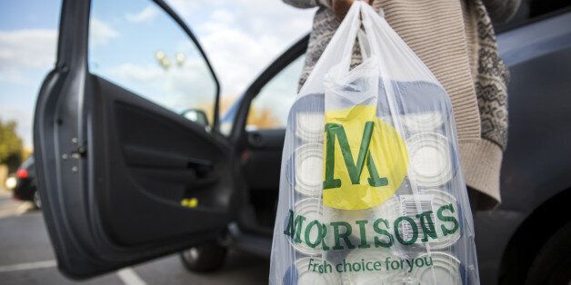 LONDON, ENGLAND - OCTOBER 02: A customer places Morrisons shopping bags in their car on October 2, 2014 in London, England. Morrisons, who reported a fall in half-year profits of more than 30%, has today announced a new loyalty card scheme. Its Match & More card will award points equivalent to the difference in price on cheaper items in Aldi, Lidl, Tesco, Sainsbury's and Asda. (Photo by Rob Stothard/Getty Images)