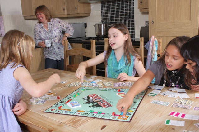 Children playing Monopoly.