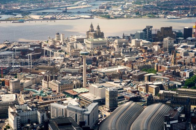 Liverpool city centre. West over Lime Street station, St. Johns Shopping Centre to the Liver Building and River Mersey, England.