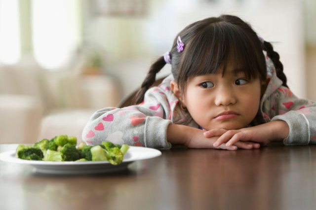 Girl looking at broccoli