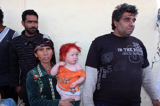 A picture taken on October 24, 2013, shows Sasha and Atanas Ruseva with one of their children in the Roma district of the central Bulgarian town of Nikolaevo. DNA tests confirmed that a Bulgarian Roma couple are the biological parents of Maria, the blonde girl found in a Greek Roma camp last week, an interior ministry offical said on October 25, 2013. DNA samples showed that Sasha Ruseva is the biological mother abd Atanas Rusev is the biological father of the child called Maria,' Bulgaria's interior ministry chief of staff Svetlozar Lazarov told reporters. AFP PHOTO / BGNES ***BULGARIA OUT (Photo credit should read BGNES/AFP/Getty Images)