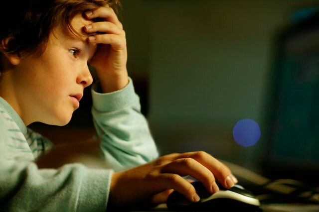 Young boy sitting at computer