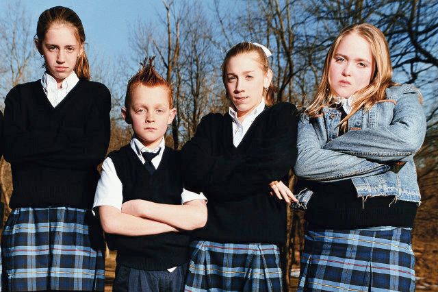 Five schoolchildren (8-13) standing with arms crossed, portrait