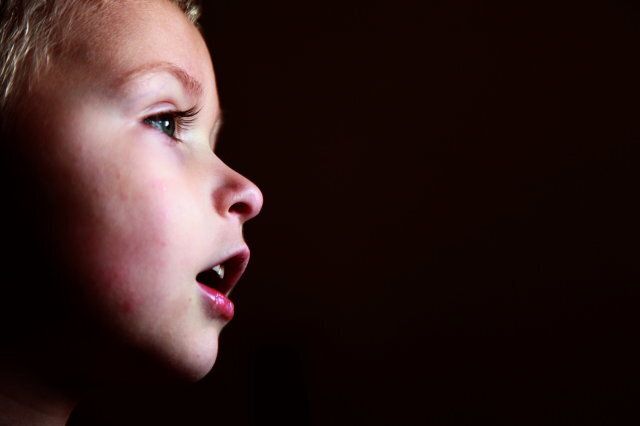 Toddler boy watching television show.