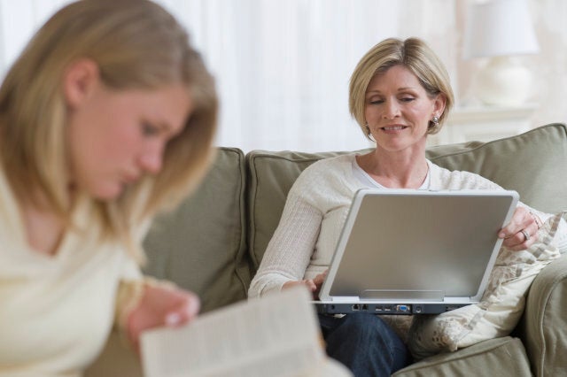 Mother and daughter relaxing in livingroom