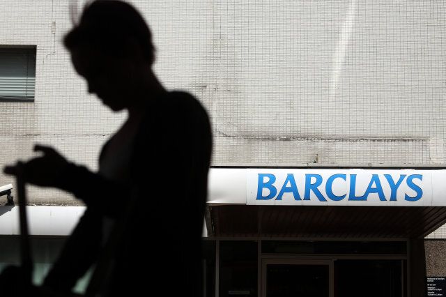 A pedestrian passes the entrance to a Barclays Plc bank branch in Hatfield, U.K., on Friday, July 26, 2013. Barclays Plc, Britain's second-largest bank by assets, may post a 19 percent gain in second-quarter profit as Chief Executive Officer Antony Jenkins tries to fend off regulators' calls to raise capital immediately. Photographer: Chris Ratcliffe/Bloomberg via Getty Images