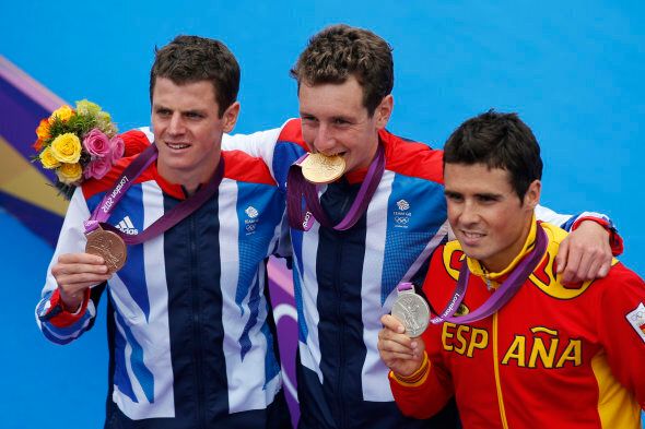 Great Britain's Alistair Brownlee, middle, displays the gold medal, Spain's Javier Gomez, right, the silver medal and Great Britain's Jonathan Brownlee the bronze medal in a ceremonyduring the men's triathlon at the 2012 Summer Olympics, Tuesday, Aug. 7, 2012, in London. (AP Photo/Jae C. Hong)