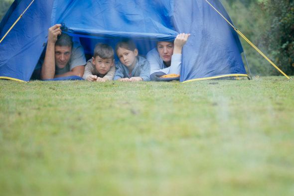 Family in Tent Looking at Rain