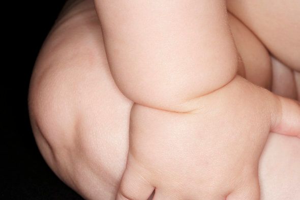 Baby boy (6-9 months), close-up of arm and leg