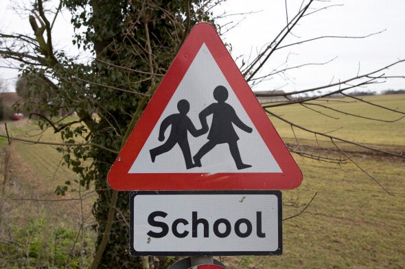 Red triangular school road sign (Photo by: Geography Photos/Universal Images Group via Getty Images)