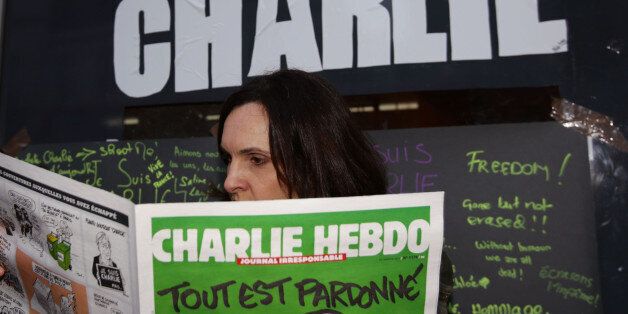 Caroline Gavazzi outside Librairie La Page bookshop in south Kensington, London, with a copy of French satirical magazine Charlie Hebdo.