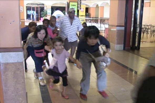 An image grab taken from AFP TV shows civilians taking cover following an attack by masked gunmen in a shopping mall in Nairobi on September 21, 2013. Masked attackers stormed the packed upmarket shopping mall in Nairobi, spraying gunfire and killing at least 59 people and wounding 175 before holing themselves up in the complex. AFP PHOTO/AFPTV/NICHOLE SOBECKI (Photo credit should read Nichole Sobecki/AFP/Getty Images)