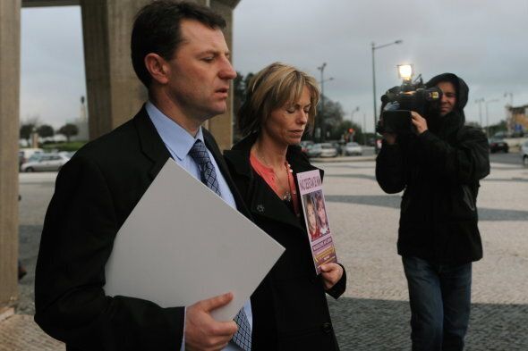 Gerry (L) and Kate (C) McCann hold signs portraiting their missing daughter Madeleine reading 'don't give me up' as they leave the Tribunal Civil de Lisboa in Lisbon on February 10, 2010, after the last court session of their libel action against Goncalo Amaral the Portuguese police officer who led the initial probe in the case. Kate and Gerry McCann are suing Amaral for 1.2 million euros (1.7 million dollars) for defamation over allegations he made in a book that their daughter was dead and that they were involved in her disappearance. Madeleine went missing from a holiday apartment in the Algarve resort of Praia da Luz on May 3, 2007, a few days before her fourth birthday, as her parents and their friends dined at a nearby restaurant. AFP PHOTO/ FRANCISCO LEONG (Photo credit should read FRANCISCO LEONG/AFP/Getty Images)